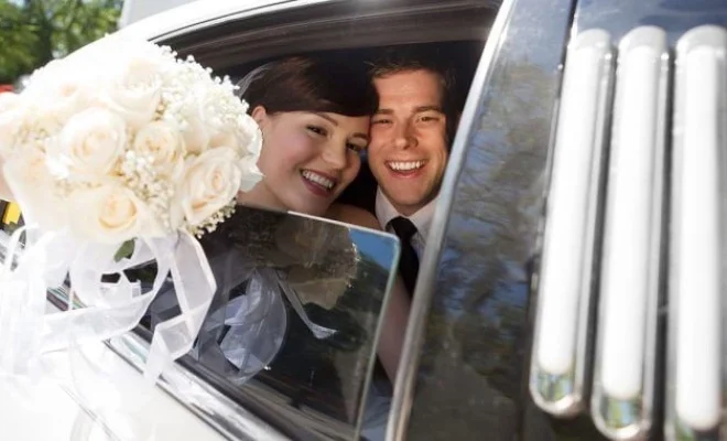Couple taking a perfect wedding ride in luxury car